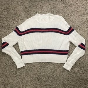 White sweater. Blue and white stripes.